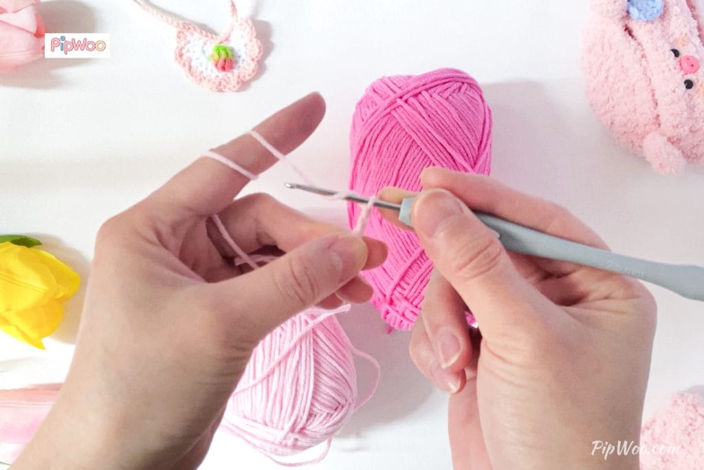 Artisan meticulously crocheting a doll outfit, showcasing intricate hand-stitch details.