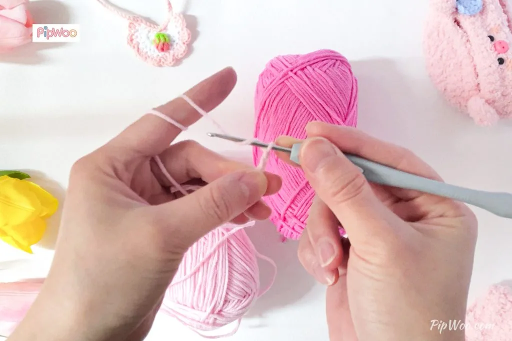 Artisan meticulously crocheting a doll outfit, showcasing intricate hand-stitch details.