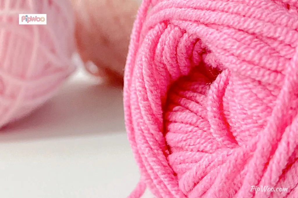 Close-up of high-quality natural yarn balls with vibrant colors and soft texture used in handcrafted doll outfits.