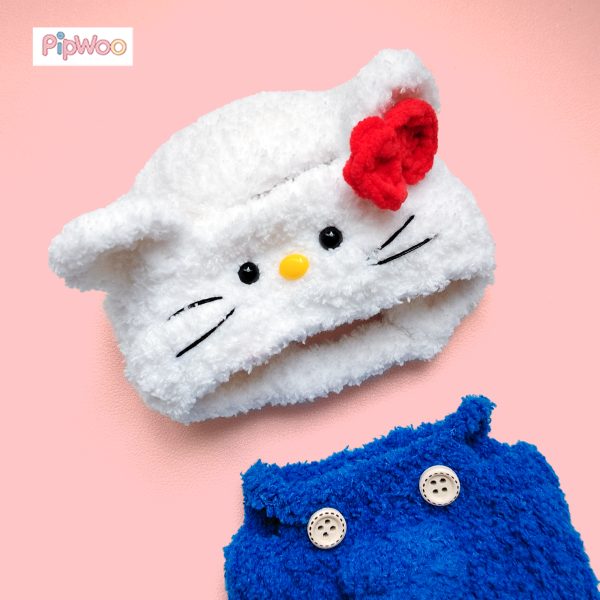 Close‑up of Crochet Labubu Clothes – Sweet Kitty featuring the red crochet bow and embroidered whiskers on the hood.