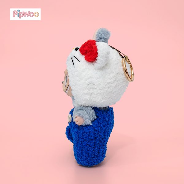 Side profile of Crochet Labubu Clothes – Sweet Kitty displaying the hood’s ear shape and textured crocheted overalls.