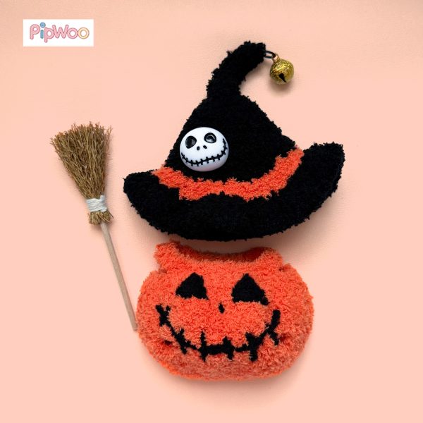 Flat lay of Crochet Labubu Clothes – Jack-o’-lantern showing the pumpkin romper, witch hat, and broom accessory together.