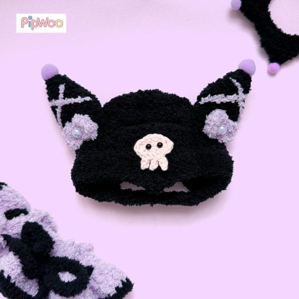 Close‑up of Crochet Labubu Clothes – Kuromi featuring the crocheted skull emblem and raised stitch texture on the hat.